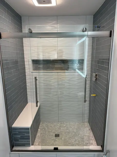 Finished shower with sliding glass door, tiled bench and recessed niche
