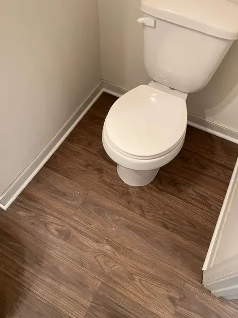 Wood-look plank flooring in a half bathroom