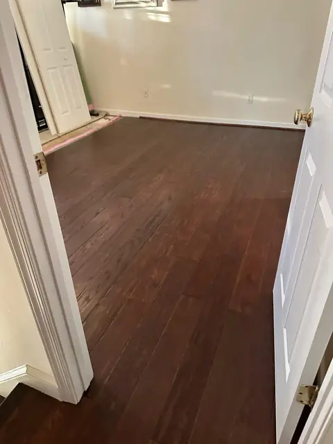 Dark wood flooring in a bedroom