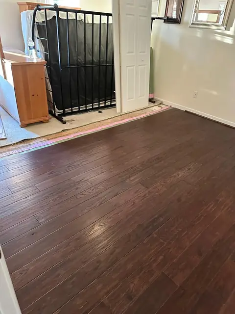 Dark wood flooring installed in a spare room