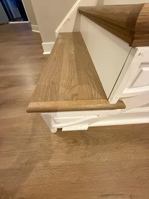Stair tread and landing finished in wood-look flooring