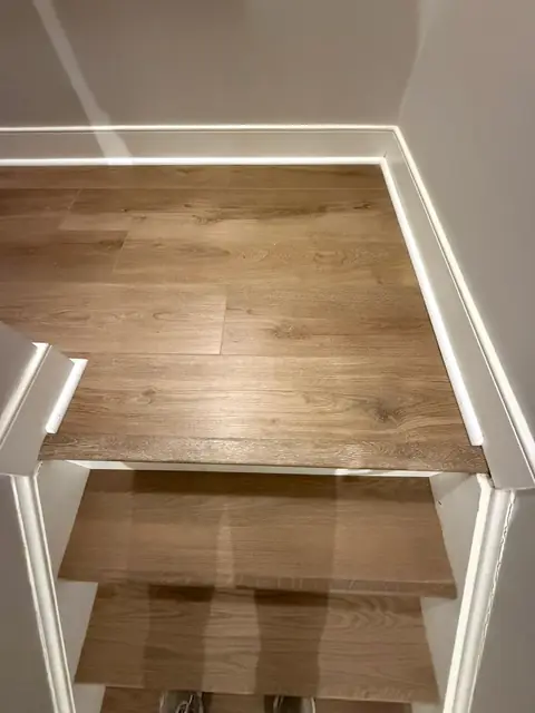 Top of the stairs with wood-look landing and treads