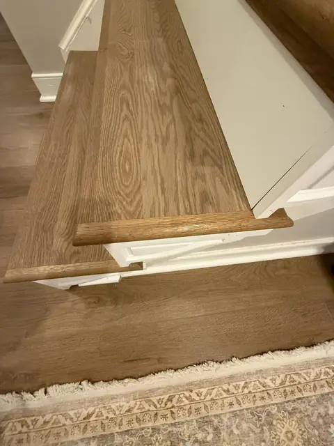 Stair landing with a wood-look tread and matching floor
